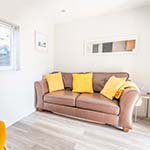 brown leather sofa with yellow cushions on 